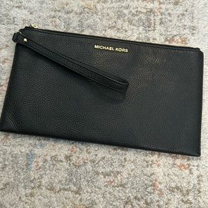 Michael Kors wristlet. Black leather. Slots for cards inside.